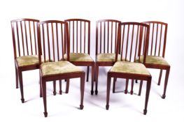 A set of six mahogany dining chairs with slat back and green upholstered drop in seats.