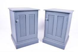 A pair of modern grey painted cabinets.