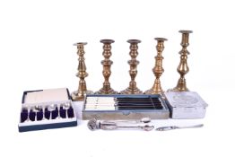 A collection of assorted metalware items. Including five brass candlesticks, cutlery, etc.