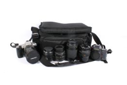 A group of 35mm film cameras and lenses. Including a Pentax MZ-30 with a Sigma Zoom 28-200mm 1:3.