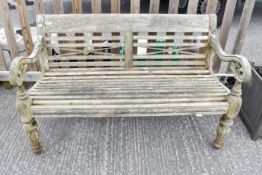 A 20th Century weathered teak garden bench with slat back and seats.