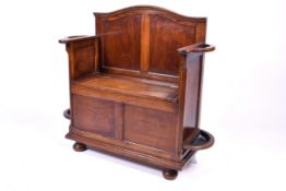 An early 20th century oak hall seat stick stand.