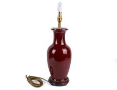 A contemporary Chinese sang de boeuf vase table lamp. Raised on a turned wooden base.