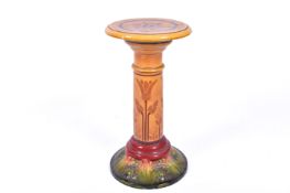 Late 19th/early 20th century glazed pottery pedestal. Having a circular top and base.