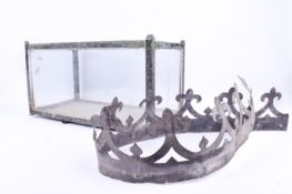 A small vintage glass fish tank or terrarium and a metal decorative strip.