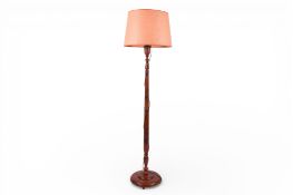 A 20th Century Chinese camphor wood standard lamp with shade.