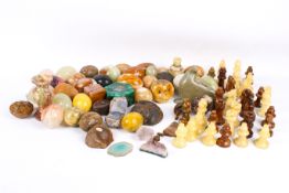 A collection of assorted carved stone items. Including hardstone eggs, chess pieces, etc.