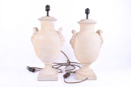 A contemporary pair of painted terracotta urn shaped table lamps. Raised on square bases.