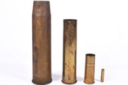 Four brass shell cases of various sizes. dates 1917, 1918 & 1942. Largest H64cm x 16cm diameter.