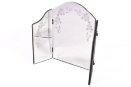 A modern folding dressing table mirror with bevel edge and floral detail.