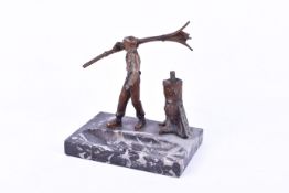 A table top lighter formed as a man carrying skis, on marble plinth.