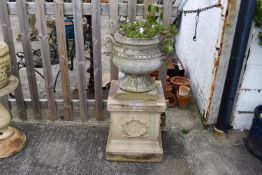 A large reconstituted stone urn and a plinth.