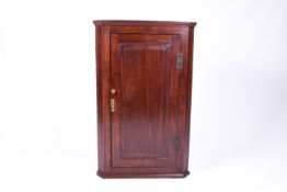 A Georgian mahogany hanging corner cupboard.