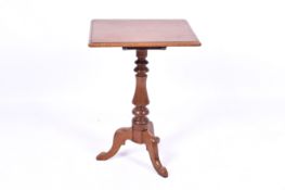 A Victorian mahogany tilt top tripod table. Having a rectangular top with a turned baluster column.