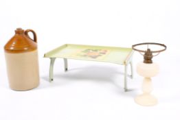 A salt glaze earthenware cider flagon, a folding tray and a glass table lamp.