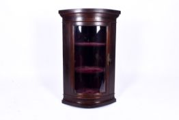 A Georgian curved glazed corner cabinet. Door opening to reveal two fixed shelves.