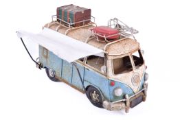 A 20th Century model of a VW camper van. Suitcases to the roof and pull out canopy. rust present.