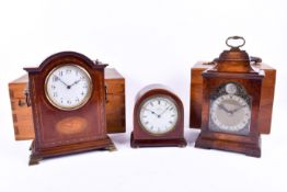 Three assorted 20th century mantel timepieces with two wooden boxes. The smallest retailed by W.