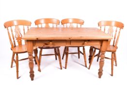 20th Century pine farmhouse style table with four pine dining chairs.