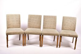 A set of four contemporary dining chairs.