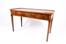 A 20th century Georgian style oak writing table or desk with three drawers.