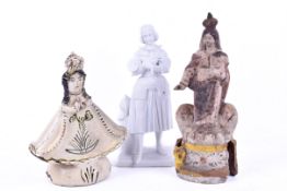 A group of three assorted ceramic figures.