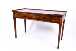 A 20th century Georgian style oak writing table or desk with three drawers.