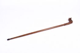 A 20th Century walking staff made from a single piece of hardwood. With dragon head carved handle.