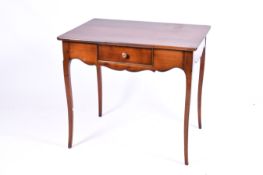 A 20th century French style writing or side table with single drawer. Raised on cabriole supports.