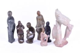 A group of seven assorted carved soapstone abstract figures.