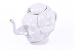 A Carlton ware 'Spitting Image' Margaret Thatcher teapot with lid.