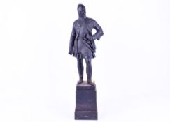 Cast iron figure of a knight wearing chainmail. Rasied on a square plinth.