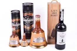 Three graduated Bells whisky pottery bell shaped bottles,