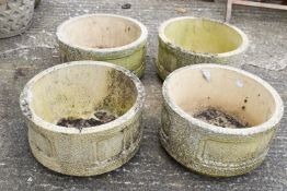 Four matching 20th century Cotswold Studios Ltd weathered stone garden planters,