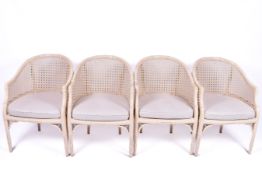 A set of four circa 1980s Hollywood Regency style bamboo and cane work tub chairs.
