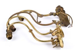 Four assorted early 20th century converted brass gas wall lights.
