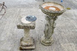 A reconstistuted stone garden bird bath and a sundial.