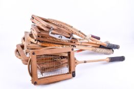A collection of early wooden squash, tennis and badminton racquets. Most with a press.
