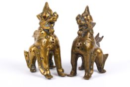 Pair of 20th century brass stone set Burmese Chinthe temple guardian dogs.