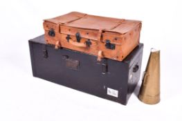 A large vintage ebonsied trunk, a suitcase and a brass megaphone.