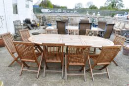 A large teak table and ten folding chairs. Eight plus two carvers, in good order and sturdy.