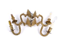 Four contemporary brass wall light sconces. Having asymmetric cast brass decoration.