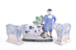 Three modern Rye pottery items. Including a pig farmer, a bull and a cow.