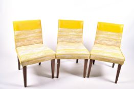 A set of three contemporary dining chairs.