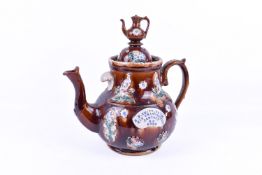 A large 'Measham' barge ware teapot (spout restored) with a teapot finial, dated '1909'.