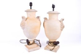 A contemporary pair of painted terracotta urn shaped table lamps. Raised on square bases.