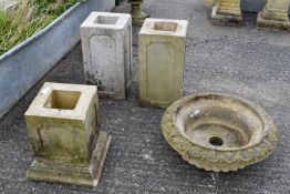 Three square reconstituted stone pedestals and a shallow basin.