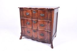 A 19th century oak Dutch Baroque style serpentine commode. Having three drawers.