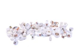 A quantity of crested China, including dishes, small jugs and vases.