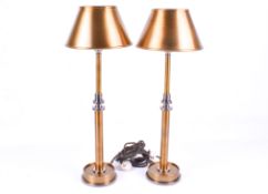 A pair of contemporary Pooky Metro table lamp with round base and metal shade.